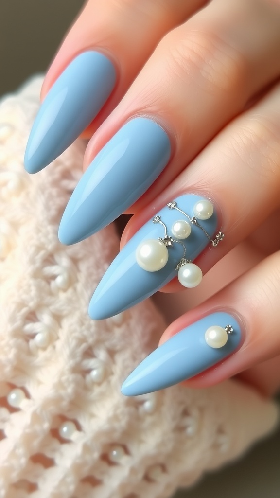 Nail design featuring powder blue polish with pearl and rhinestone accents